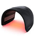 Galaxy Zero Trinty Red Light Therapy Device photographed at an angle with red LED rows lit under the black arch