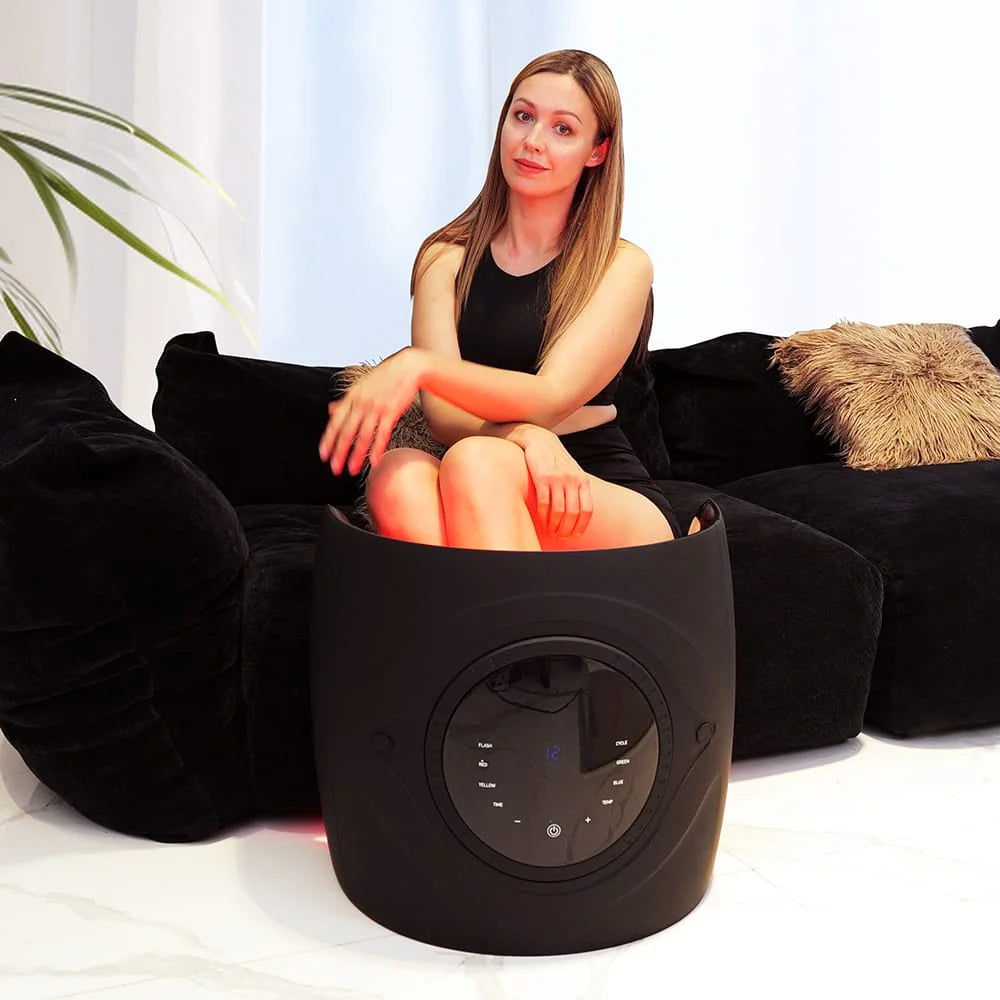 Seated leg session on a sofa with the Galaxy Zero Trinty LED Device timer showing 12 minutes on the control panel