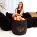 Seated leg session on a sofa with the Galaxy Zero Trinty LED Device timer showing 12 minutes on the control panel