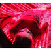 Person in protective goggles lying on the lit base of the Kore KoreKapsule Full Body Red Light Therapy Device for a session