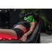 Relaxed client under green LED light on the Vacu Activ Red Couch Oxy Full Body Therapy System headrest