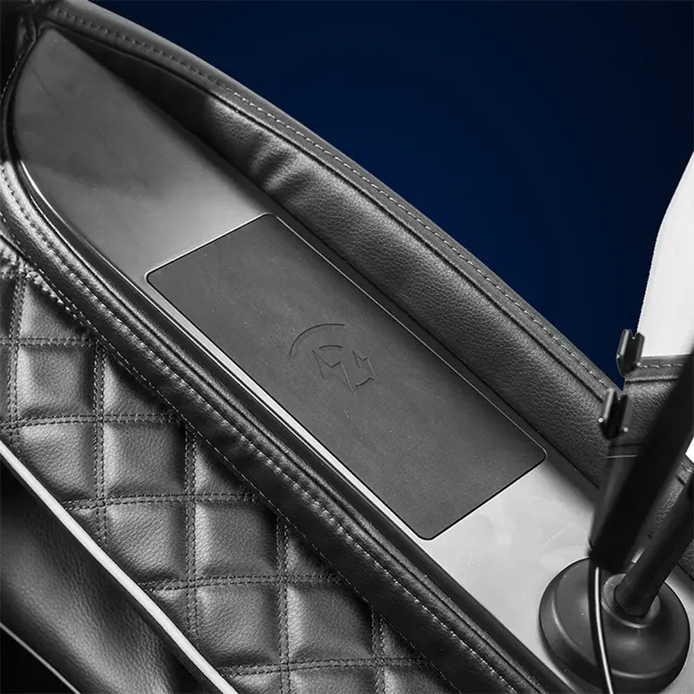 Embossed wireless charging pad set into the leather armrest of the Infinity Aura Elite