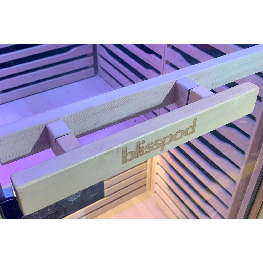 Branded interior wood handle bar mounted on the glass door of the Blisspod Helsinki Red Light Therapy Sauna