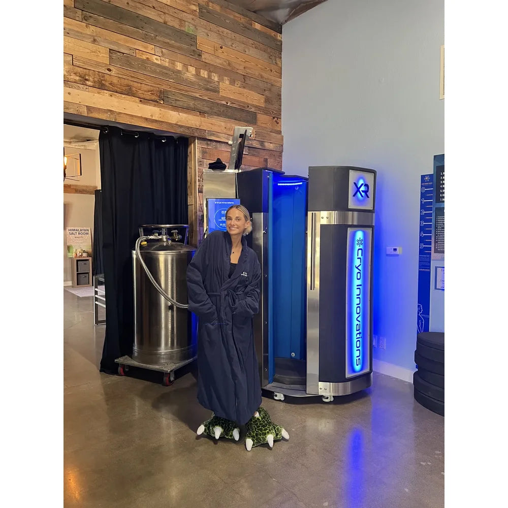 Client in robe between nitrogen dewar and chamber showing full install footprint of the Cryo Innovations XR