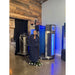Client in robe between nitrogen dewar and chamber showing full install footprint of the Cryo Innovations XR