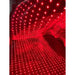 Rows of red LEDs glowing inside the Kore KoreKapsule Full Body Red Light Therapy Pad under a clear protective film