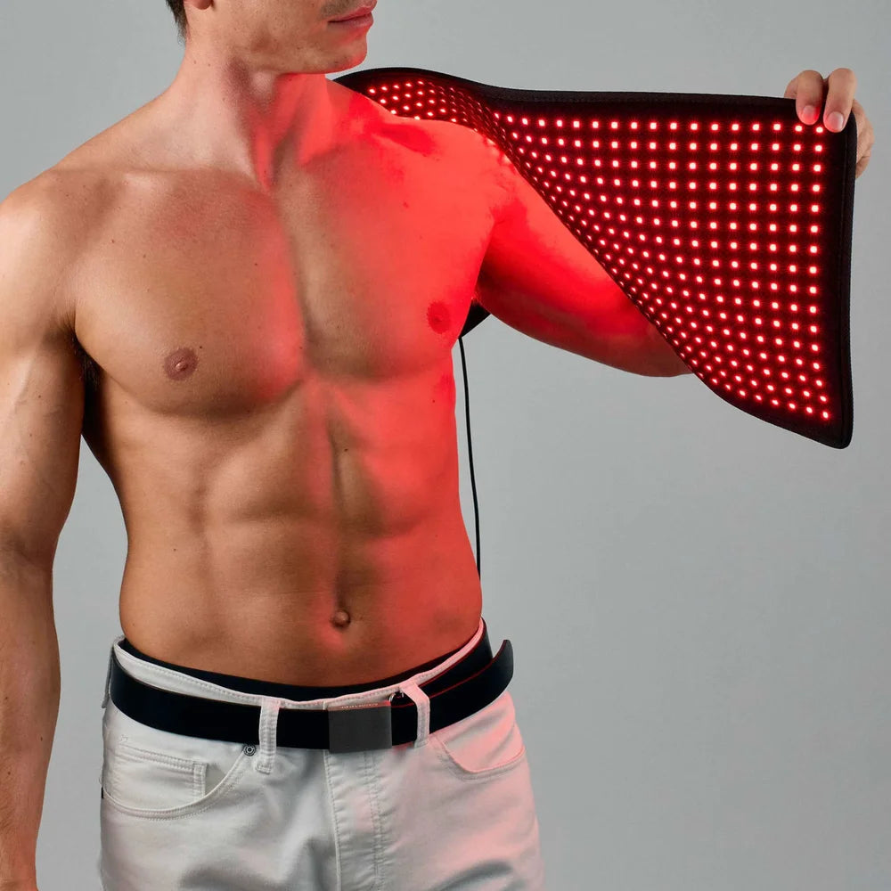 Man draping the lit long Lumara Pad over one shoulder, red light washing across his chest on a grey backdrop