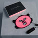 Glowing Lumara VISO LED Mask on a concrete pedestal next to its black box, cable and handheld controller