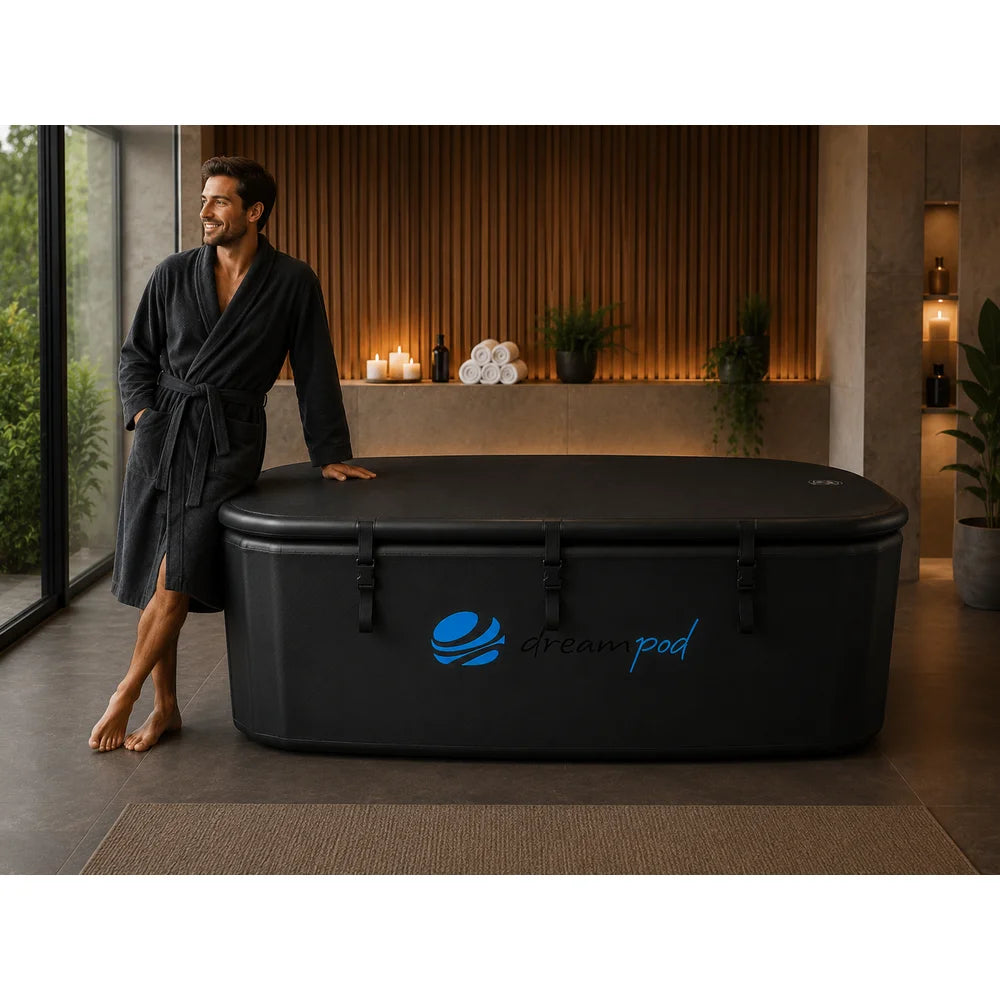 Man in a dark robe next to the padded closed lid of the Dreampod Home Float FLEX Inflatable Float Tank in a spa room