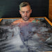 Man sitting chest-deep in floating ice inside the Revive Plunge Luxury Plunge Cold Plunge Bath