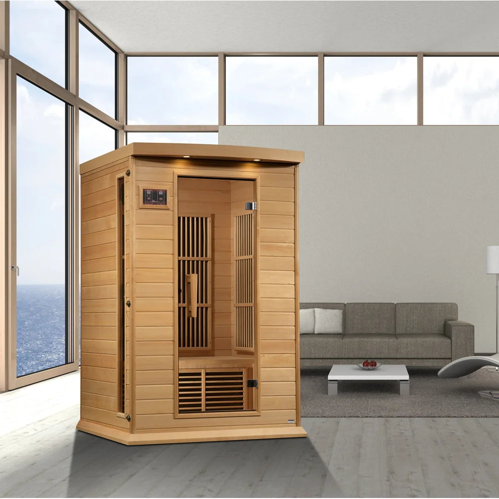 Hemlock cabin of the Maxxus MX-K206-01-ZF EMF Sauna set up in a modern living room beside ocean-view windows