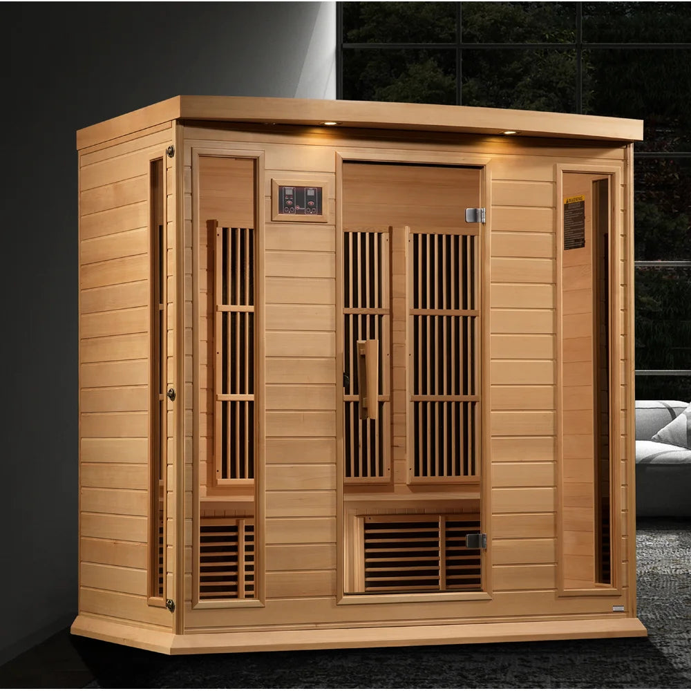Maxxus MX-K406-01 Home Sauna set up in a dark modern room with carpet, window and sofa behind the hemlock cabin