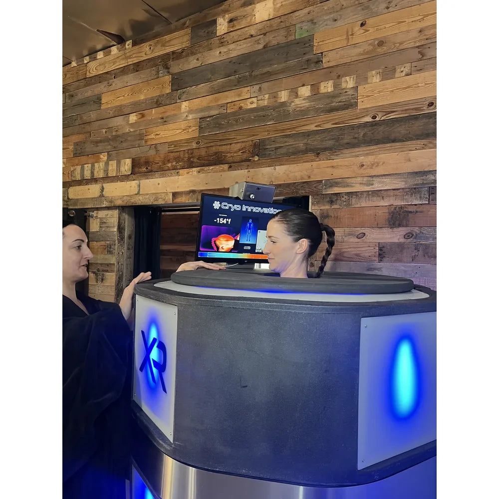 Operator beside a client in the Cryo Innovations XR Cryo Chamber with live thermal imaging at -154°f