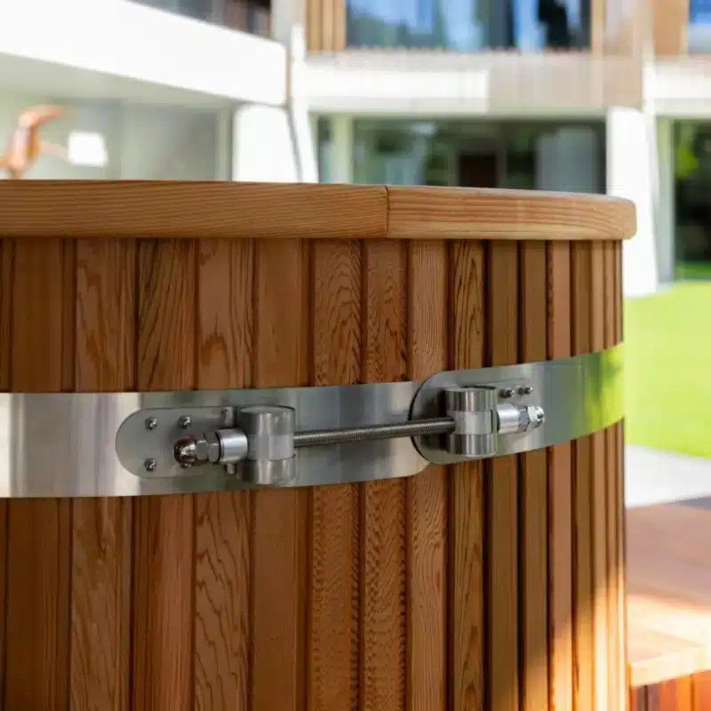 Close view of the red cedar staves and polished steel band on the Ora Ice Bath cold plunge tub