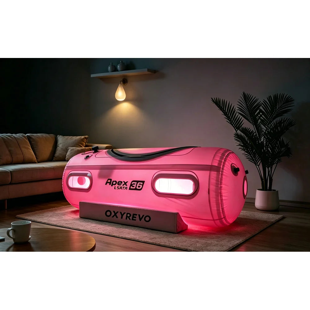 OxyRevo Apex36 Hyperbaric Chamber glowing red from the internal red light therapy panel in a dark room