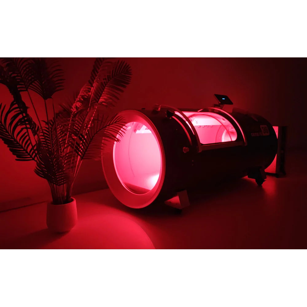 Deep red glow filling the OxyRevo Quest36 Oxygen Chamber end window in a darkened treatment room