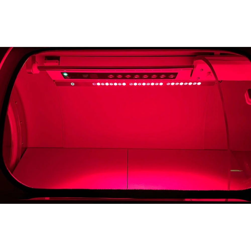 Row of lit red light LEDs mounted inside the OxyRevo Quest36 Hyperbaric Oxygen Chamber above the bed