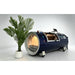 Large round end window of the navy OxyRevo Quest36 Hard Hyperbaric Chamber showing the cushioned bed inside
