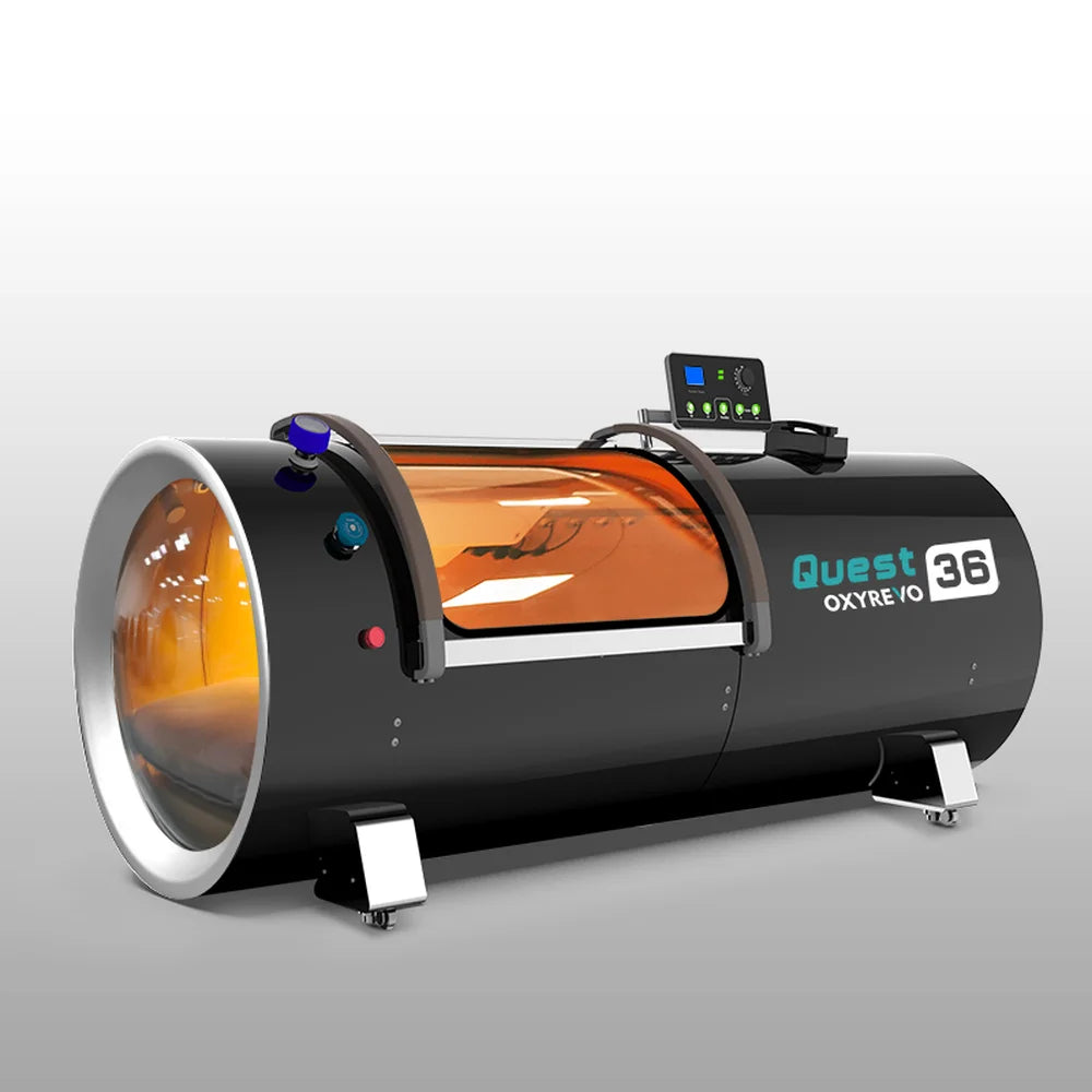 Angled studio view of the black OxyRevo Quest36 Oxygen Chamber showing end porthole, side window and casters