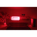 White OxyRevo Quest36 Hyperbaric Oxygen Chamber casting red light in a dark room during a combined session