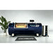 Navy blue OxyRevo Quest36 Hyperbaric Chamber shown side on with window, valves and branded floor mat