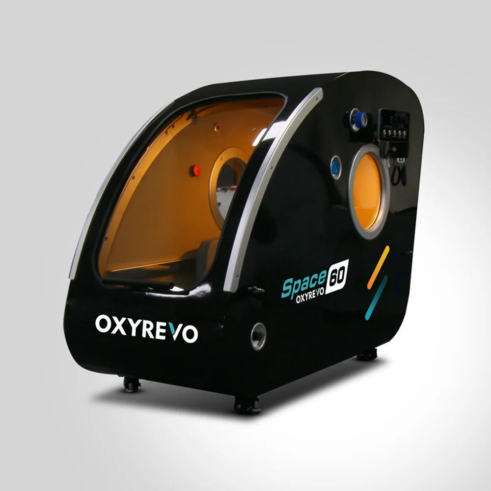 Angled view of the black OxyRevo Space60 Hyperbaric Oxygen Chamber with silver door rails and tinted glazing