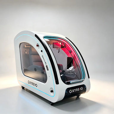 White OXYREVO Space60 Pro Oxygen Chamber at a three-quarter angle with cyan trim and grey recliner inside