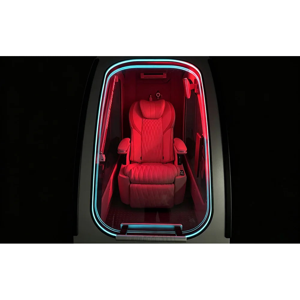 Front-on look through the doorway of the OXYREVO Space60 Pro at the recliner under red therapy light