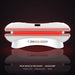 White Peak Muscle Recovery Basecamp Red Light Therapy Bed with red LEDs glowing in a dark studio