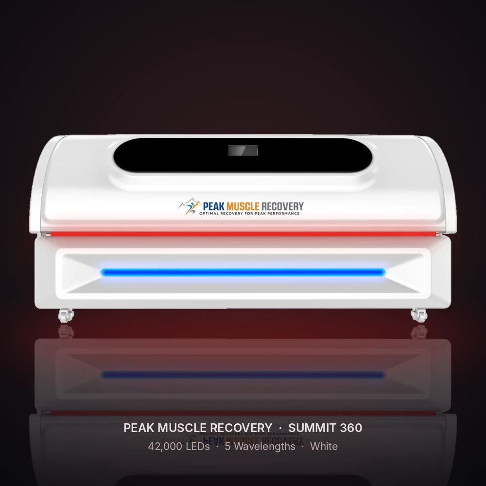 White Peak Muscle Recovery Summit 360 Red Light Therapy Bed with red LEDs glowing in a dark studio