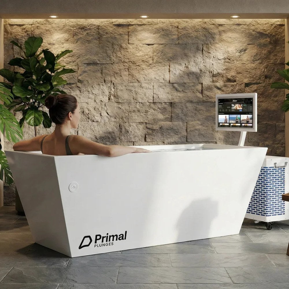 Woman inside the Primal Plunges Blizzard cold plunge at a spa
