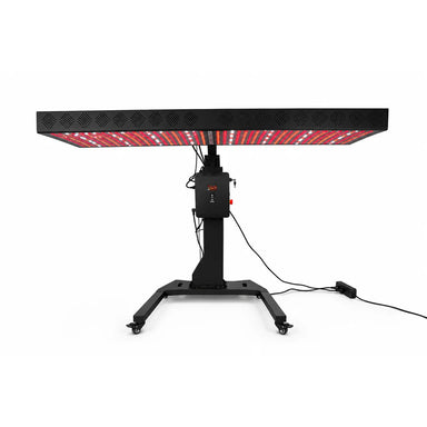 RevitalCore Apex Red Light Therapy Panel tilted flat overhead on its motorized column stand with lit red and white diodes