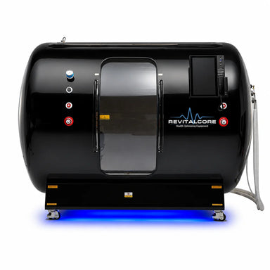 Front elevation of the RevitalCore Summit Duo Plus Hyperbaric Chamber showing the sliding entry door, gauges and touchscreen panel