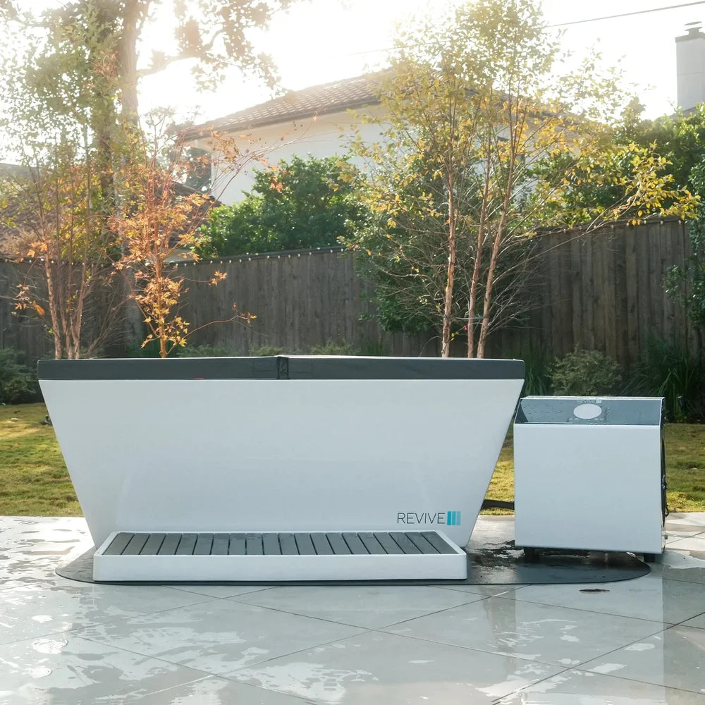 Covered Revive Plunge Acrylic Plunge Tub with step and chiller set up on a backyard tile patio