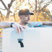 Man leaning on the padded rim at sunset while soaking in the Revive Plunge Inflatable Barrel Plunge Cold Plunge