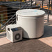 Covered Revive Inflatable Pod Plunge Ice Bath and chiller unit sitting together on an outdoor patio rug
