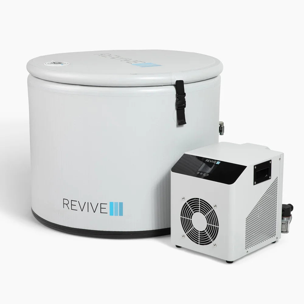 Angled studio view of the lidded Revive Inflatable Pod Plunge Ice Bath Tub beside its white chiller unit