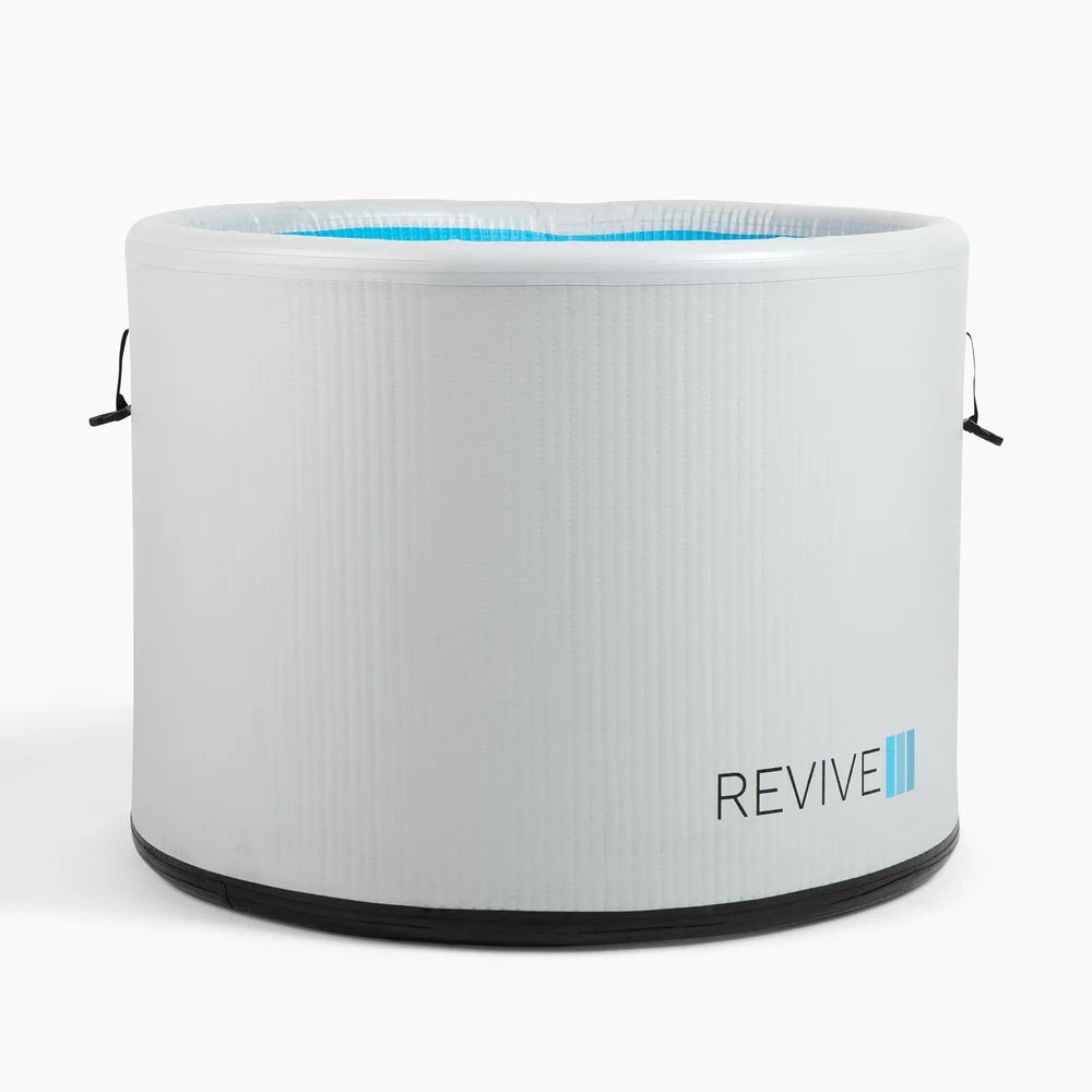 Straight-on studio front view of the Revive Inflatable Pod Plunge Recovery Tub with blue interior showing