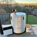 Rooftop sunset soak showing the chiller and step beside the Revive Plunge Inflatable Barrel Plunge Cold Plunge Tub