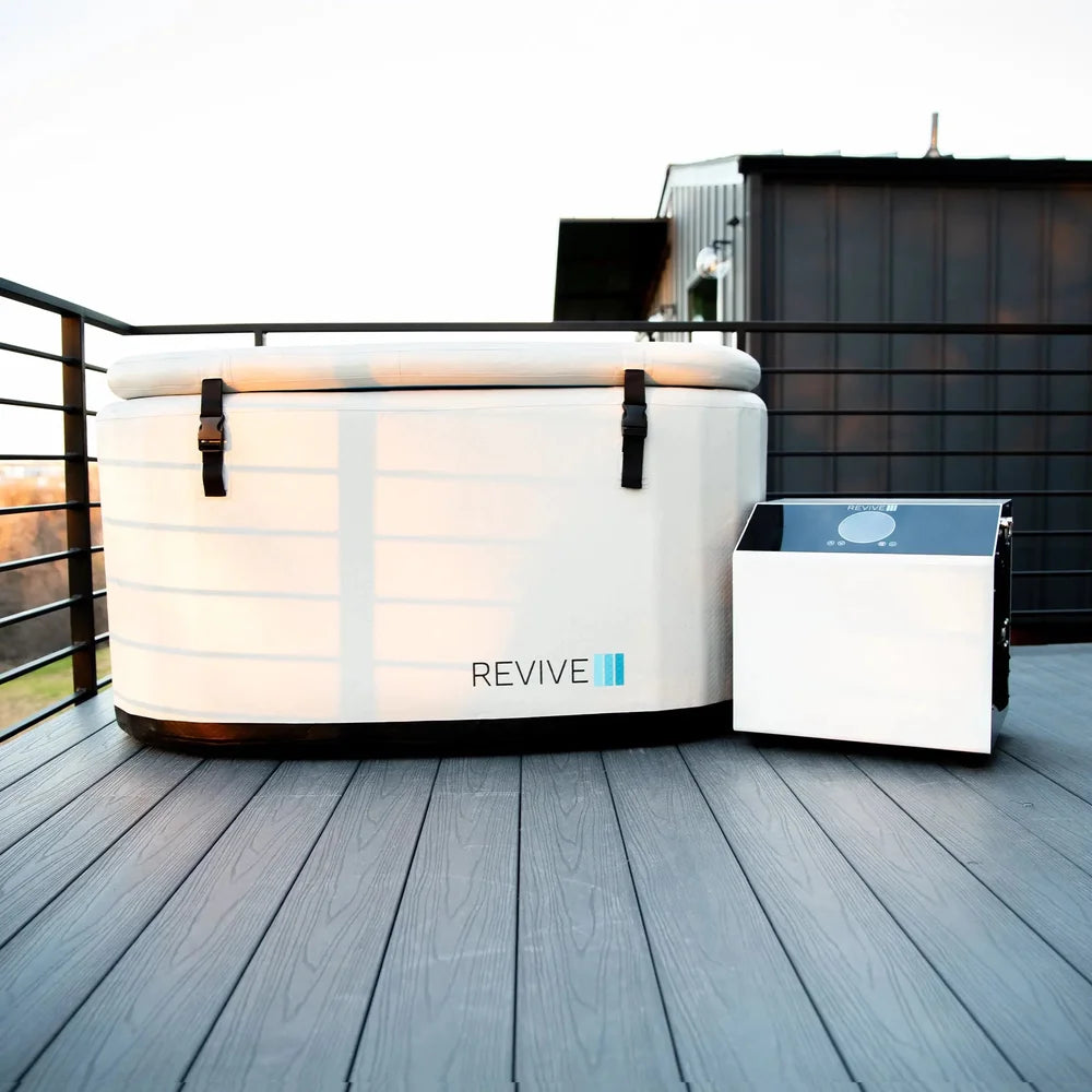 Covered Revive Inflatable Cold Plunge Pool and chiller on a wooden rooftop deck in evening light