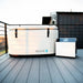 Covered Revive Inflatable Cold Plunge Pool and chiller on a wooden rooftop deck in evening light