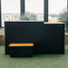 Covered Revive Luxury Plunge Cold Plunge Spa with matching step set on turf by tall city-view windows