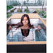 Woman submerged to the shoulders in the Revive Plunge Luxury Plunge Cold Plunge Spa in a courtyard