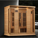 Lit hemlock cabin of the Maxxus MX-K406-01-ZF Near Zero EMF Sauna staged in a dark modern living room