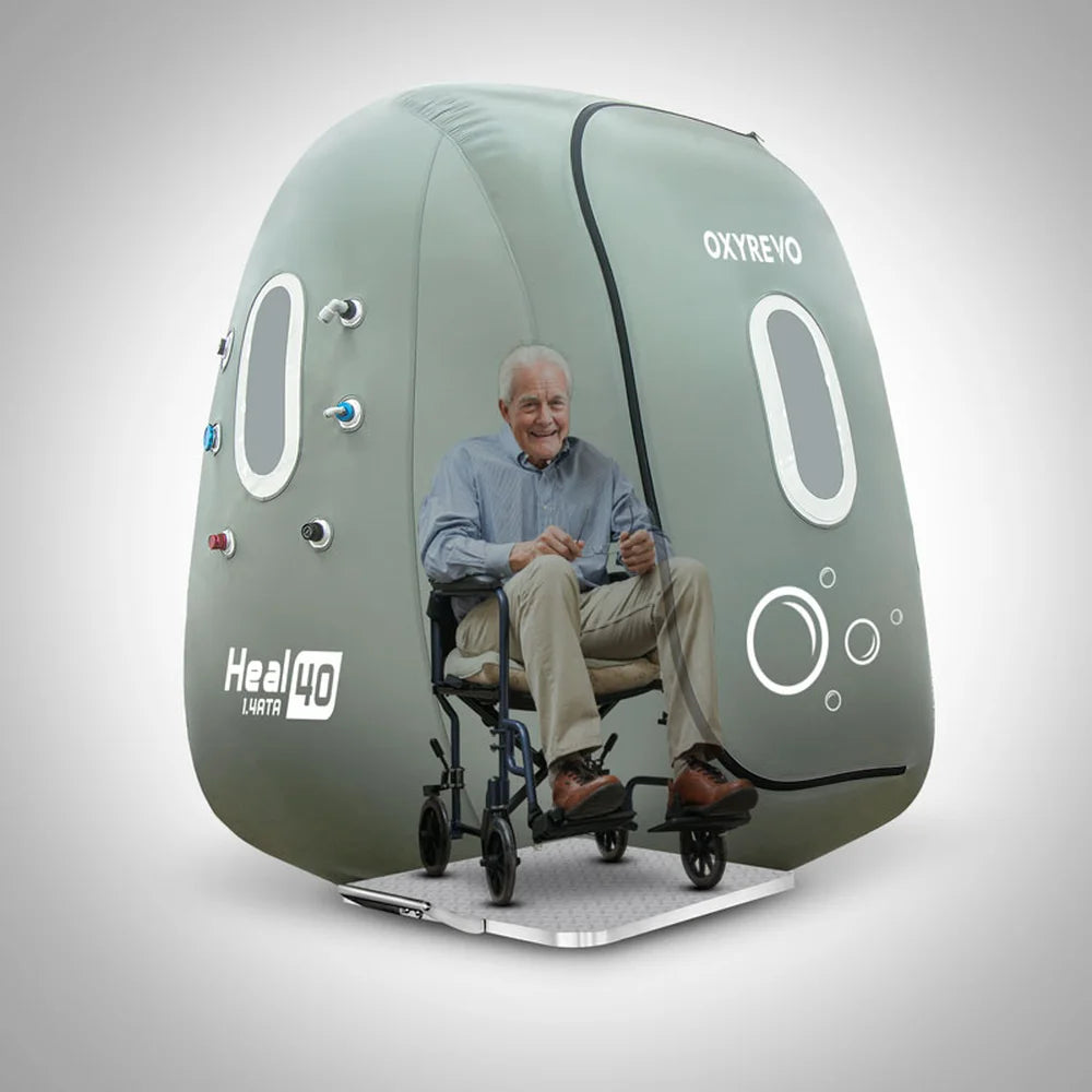 Older man in a wheelchair parked on the ramp inside the open Oxyrevo Heal 40 Oxygen Chamber