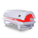 Side studio view of the Nextgen Fit Red Light Bed with lowered canopy, touchscreen panel and lit base surface