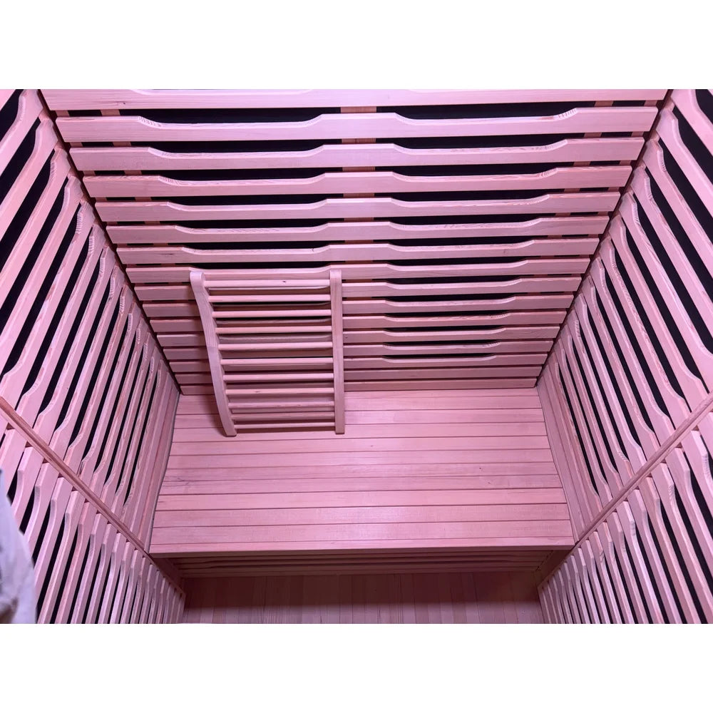Bench, backrest and carbon heater panels inside the Blisspod Milano Full Spectrum Sauna under pink light