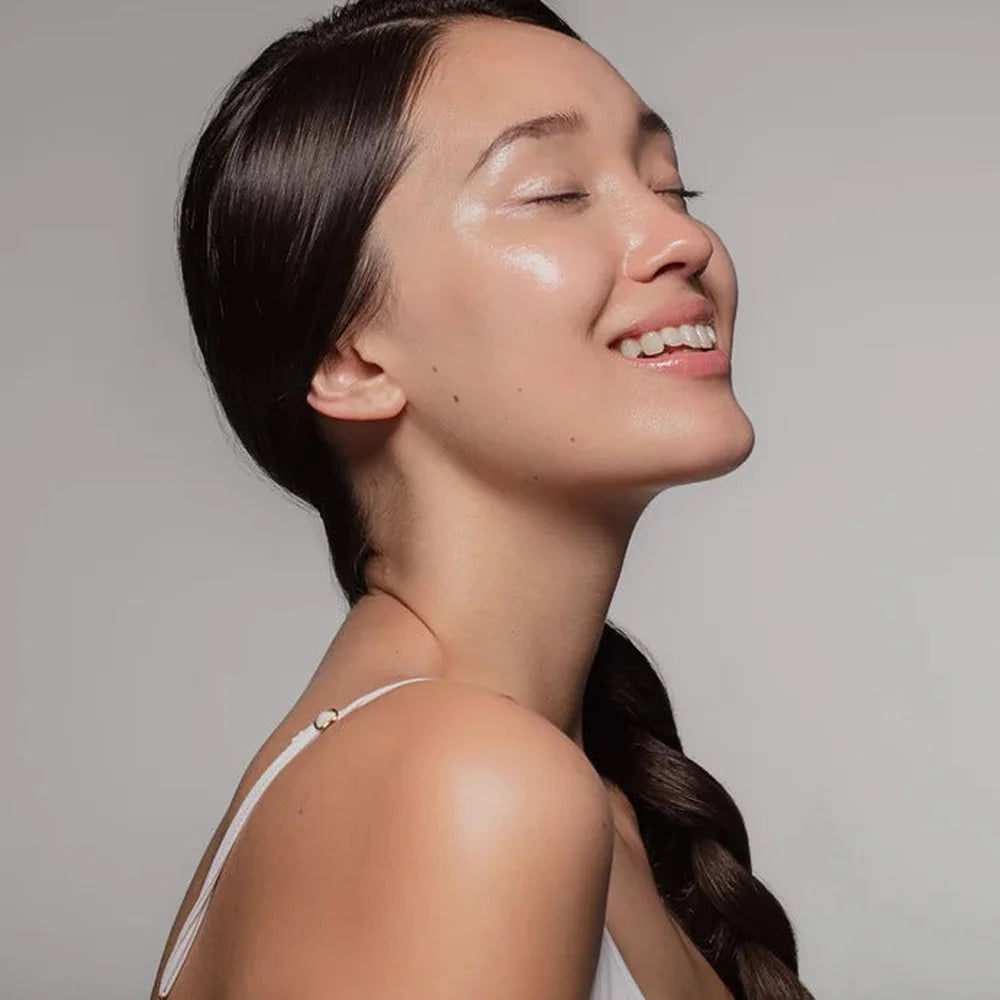 Young woman in profile with dewy glowing skin, illustrating results from the Galaxy Zero Atlas Body Wellness Device