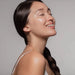 Young woman in profile with dewy glowing skin, illustrating results from the Galaxy Zero Atlas Body Wellness Device