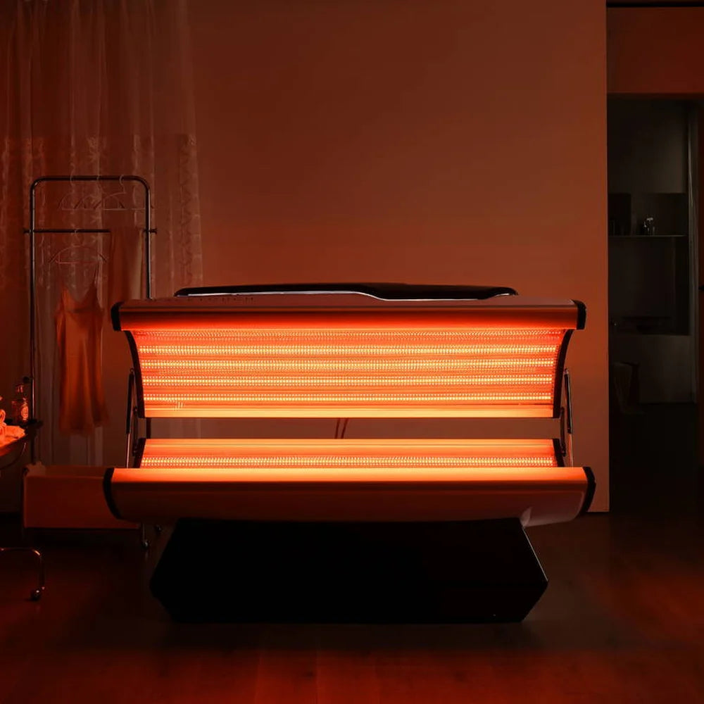 Amber orange LED rows glowing from the open canopy and lower bed of the Galaxy Zero Capsule in a dark room